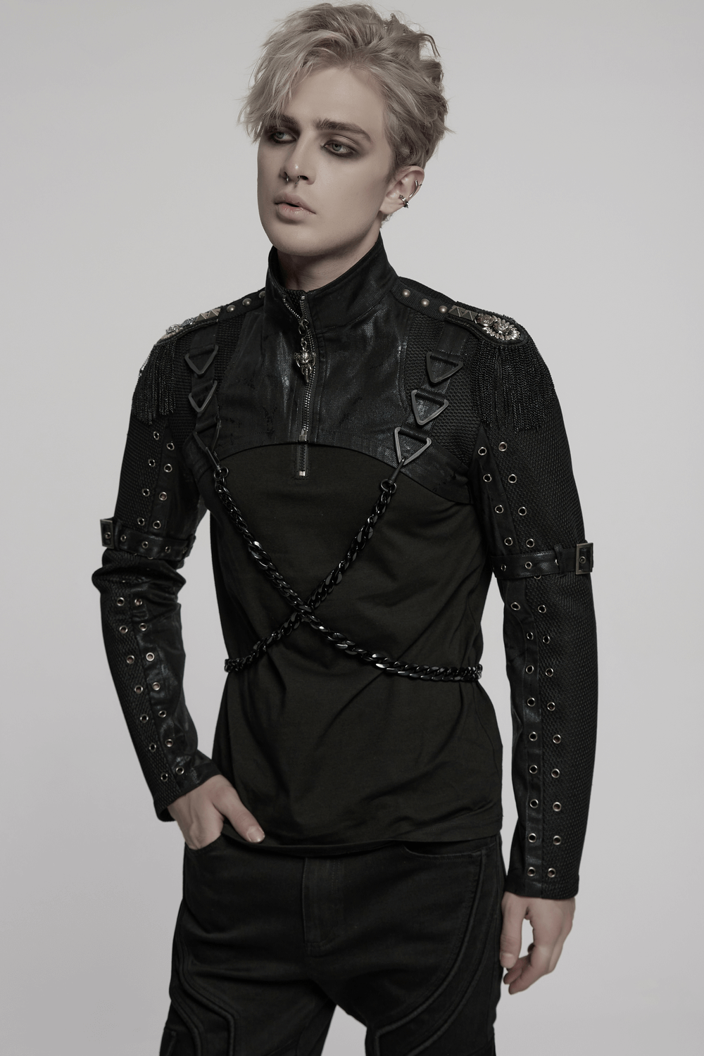 Model showcasing a punk mesh cropped jacket with chains and striking buckle details.