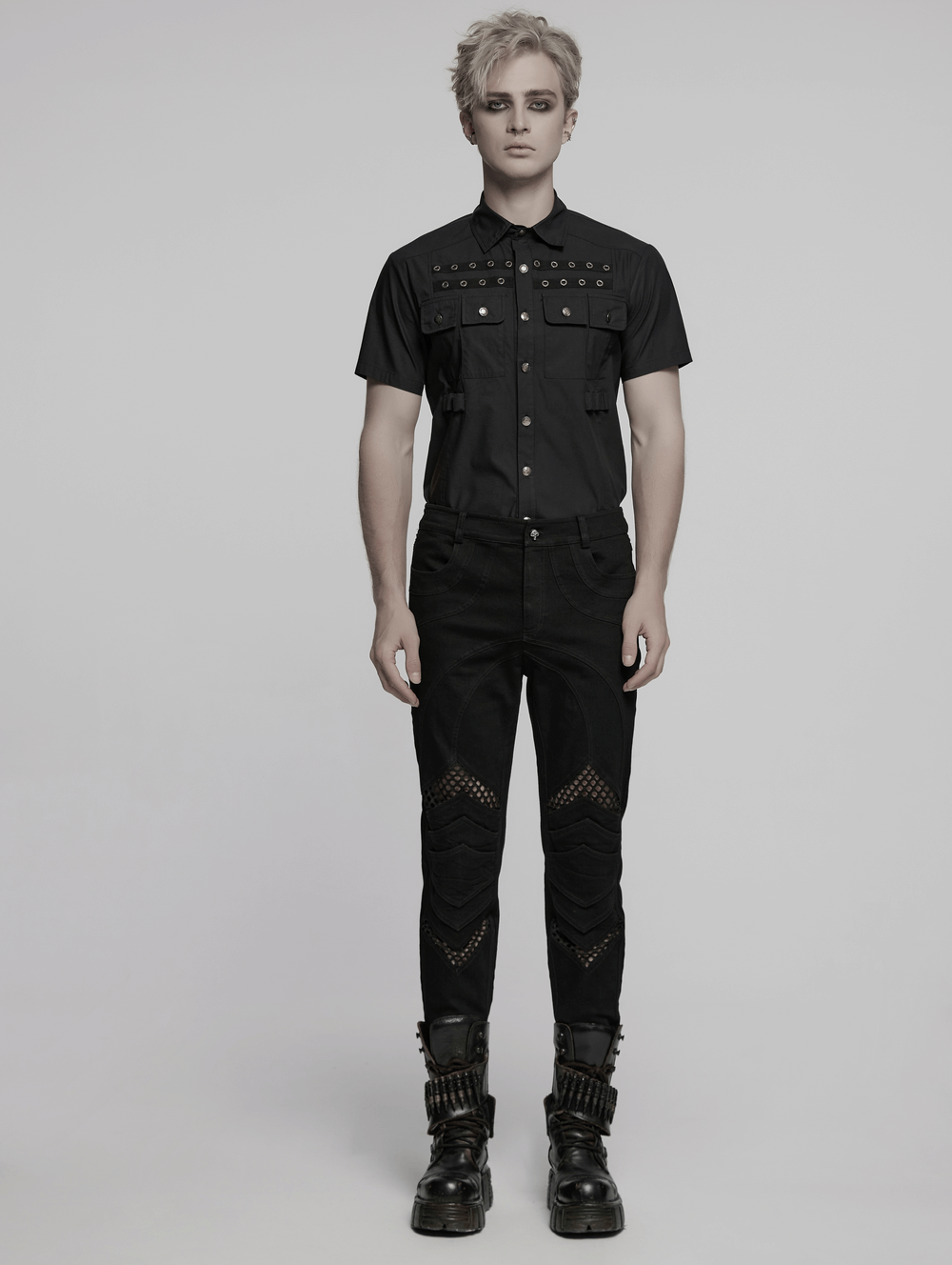 Punk mesh detailed tight pants with 3D knee pieces, styled with a studded black shirt and edgy boots.