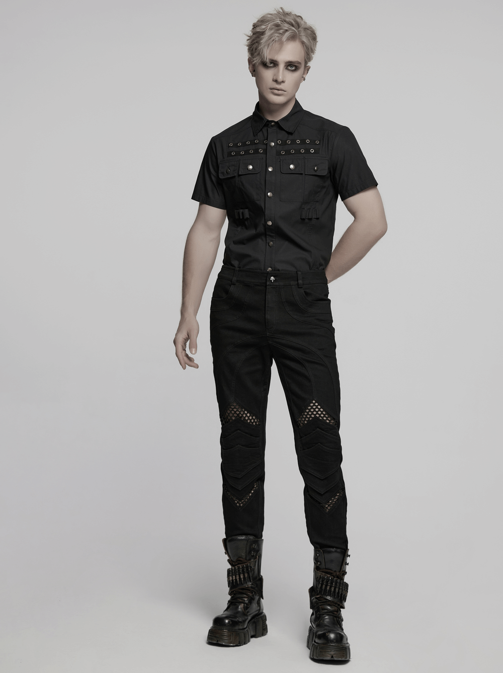 Model showcasing punk mesh detail tight pants with 3D knee pieces and edgy shirt, perfect for bold fashion enthusiasts.