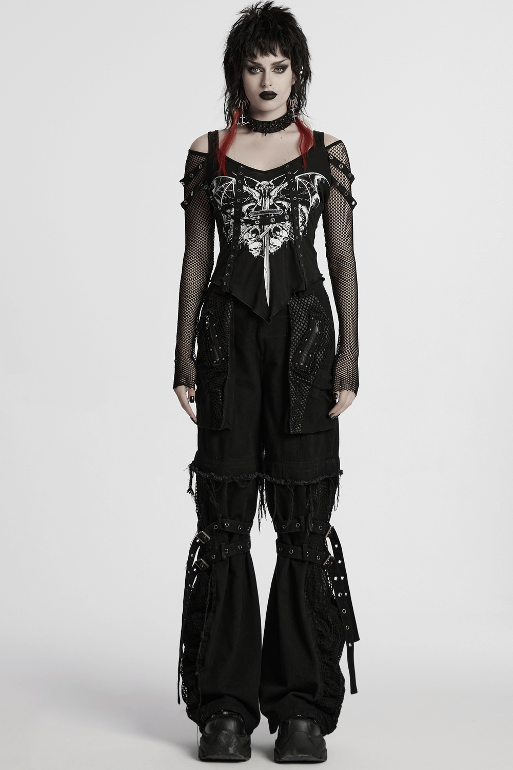 Gothic punk fashion featuring a mesh sleeved top with bat print and oversized cargo pants for an edgy look.
