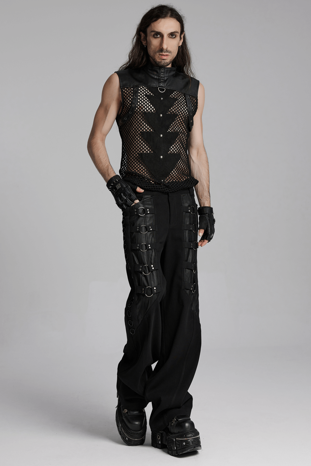 Stylish model in punk mesh sleeveless top with PU leather, showcasing edgy fashion and bold design elements.