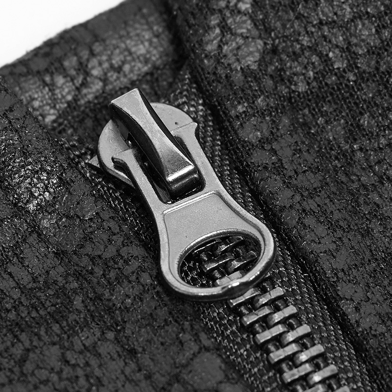 Close-up of a black zipper on micro-crack textured fabric, showcasing edgy punk style detail.