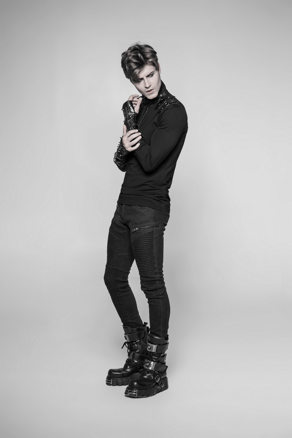 Fashionable model showcasing punk micro-crack fingerless gloves with leather detailing in a stylish black outfit.