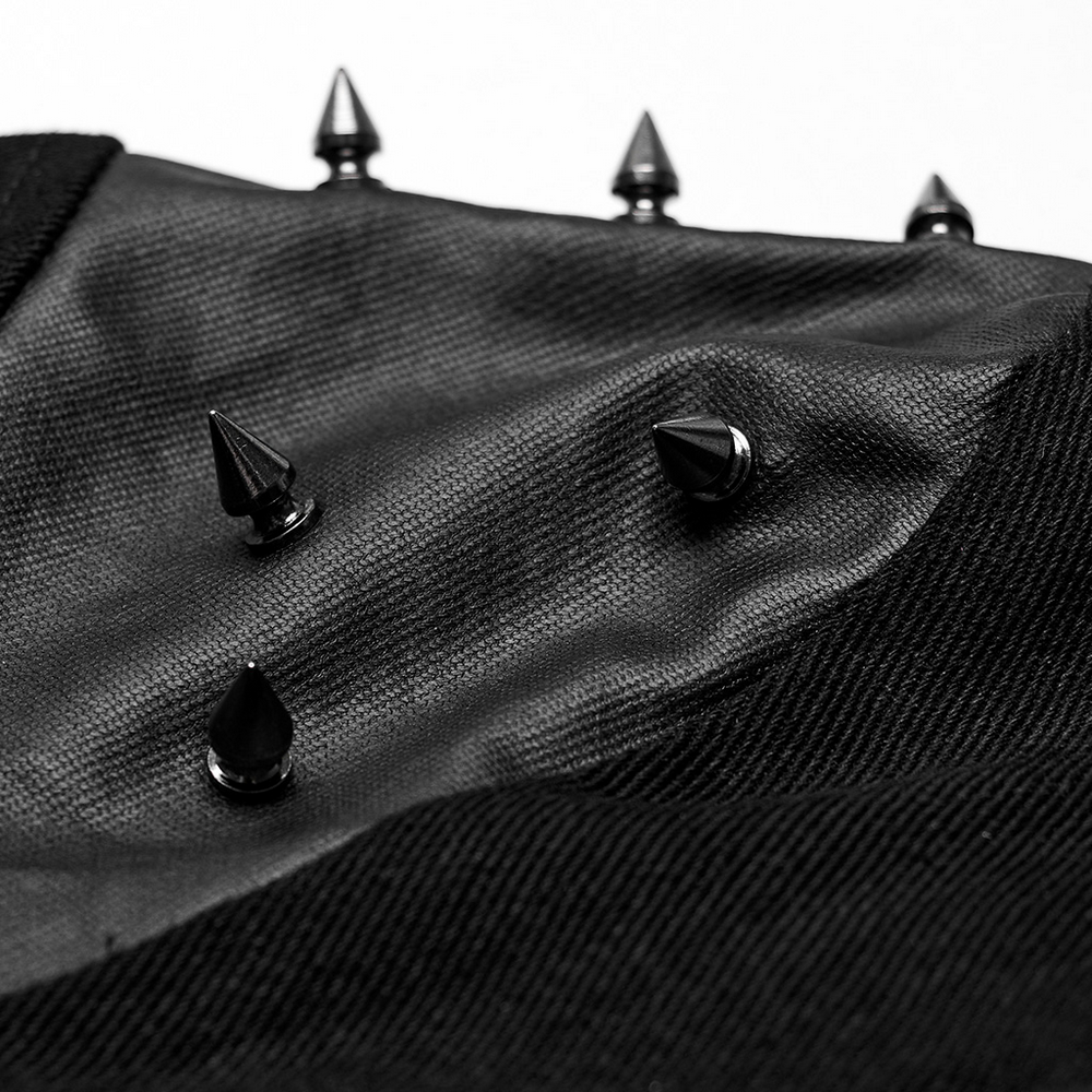 Close-up of punk harness detailing with black spikes on elastic fabric for edgy fashion.
