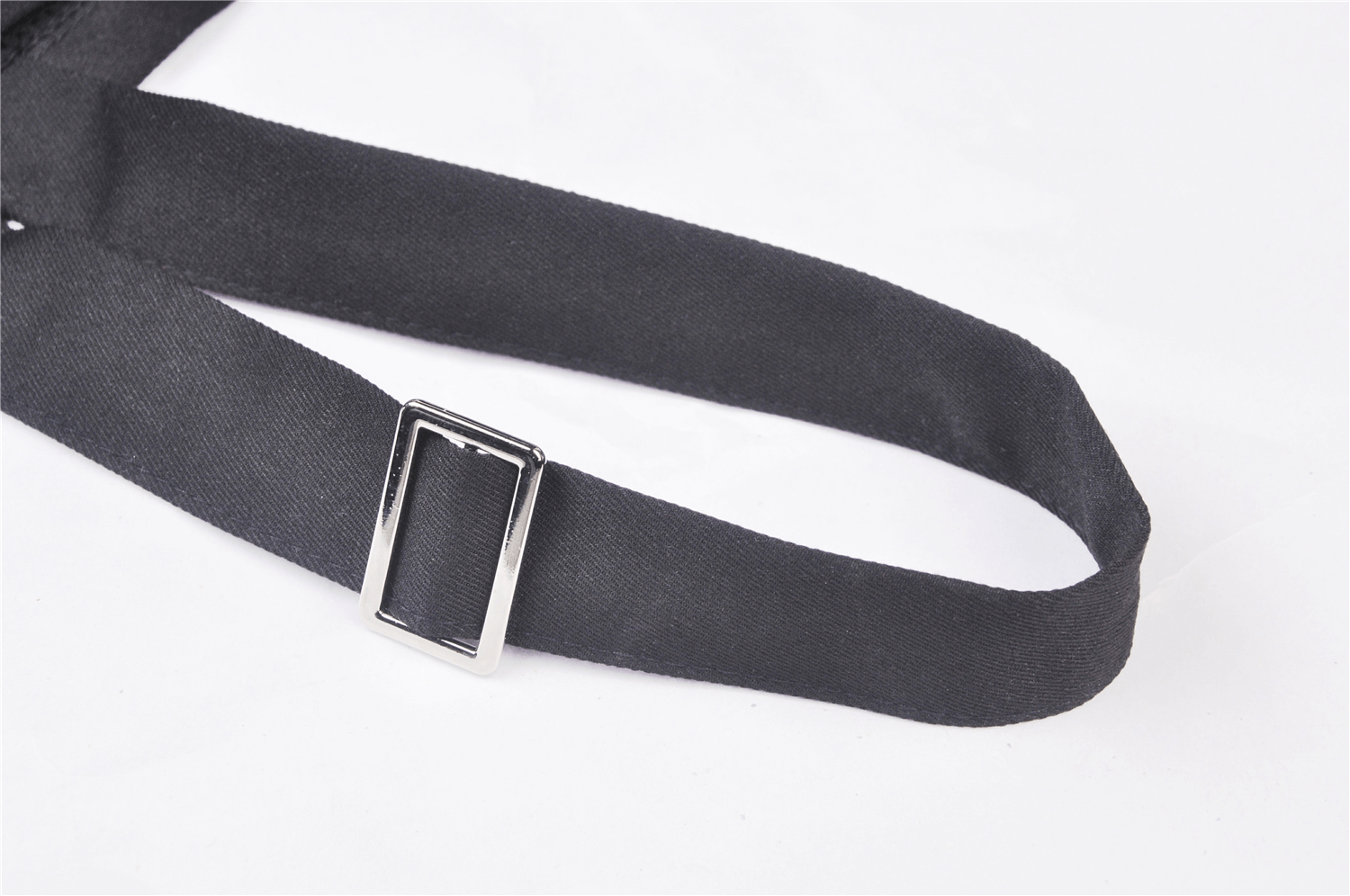Close-up of the black strap with metal buckle from a Punk Pentagram Suspender Dress, showcasing its edgy design.