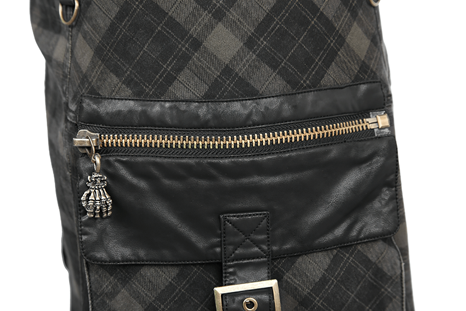 Close-up of punk plaid kilt showing stylish zipper pocket and black leather details for a modern look.