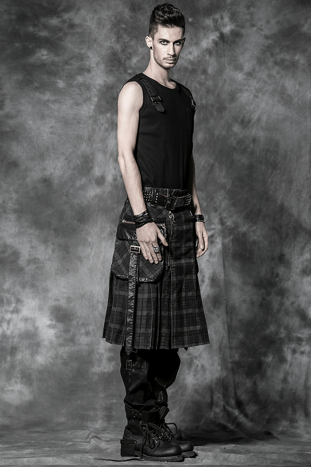 Men's punk plaid kilt with cargo pockets and zipper, styled for an edgy fashion statement.