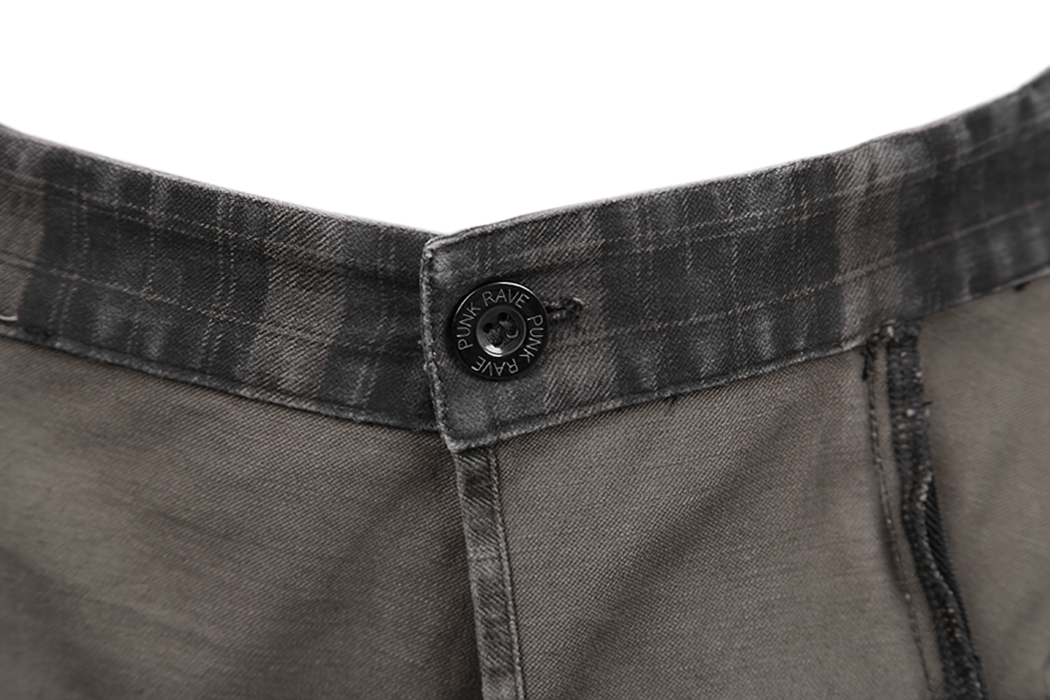 Close-up of the waistband with button detail on a punk plaid kilt featuring a black plaid design.