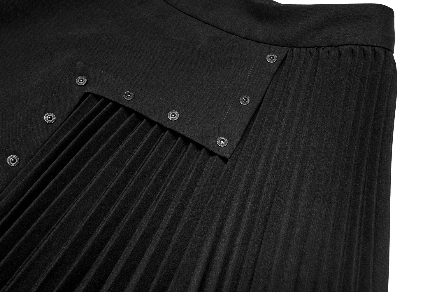 Close-up of the dark punk pleated asymmetric skirt featuring engraved nail design and geometric cut.
