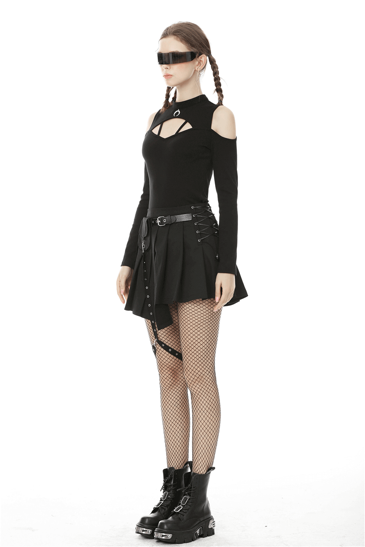 Edgy model in black gothic mini skirt with pocket and leg belt, paired with a stylish cut-out top and fishnet tights.