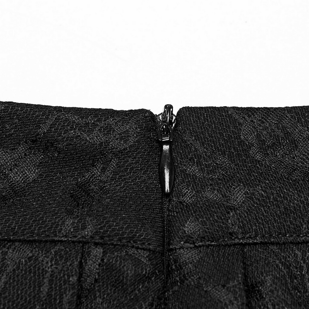 Close-up of the zipper detail on a punk pleated skirt with floral net design and detachable chains.