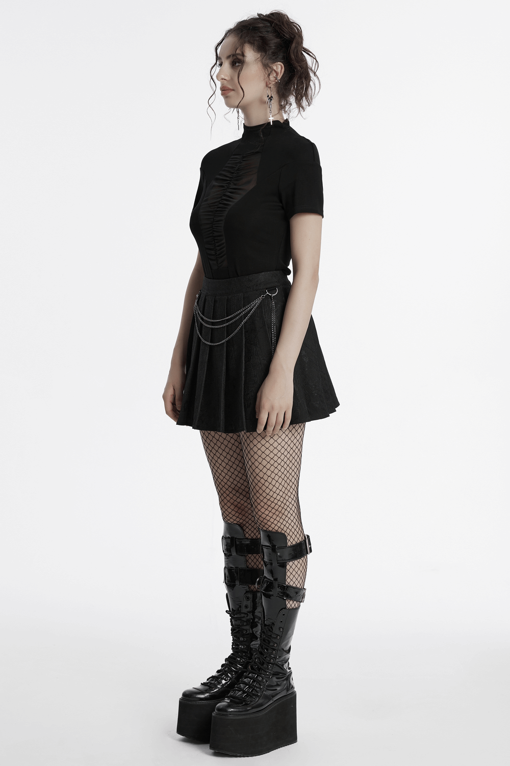 Punk pleated skirt with chains, floral net, and stylish fishnet stockings, showcasing a bold and edgy outfit.