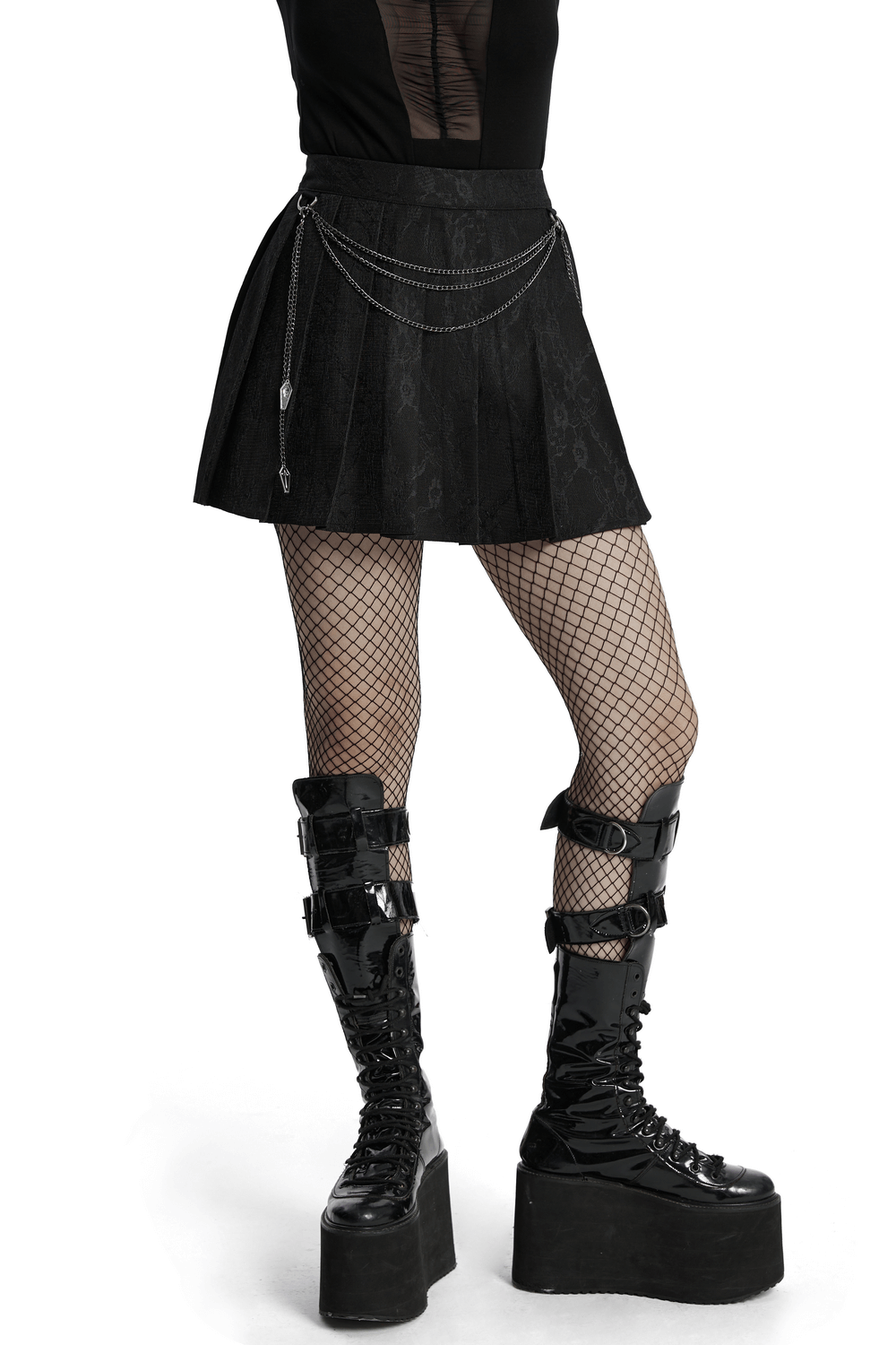 Edgy punk pleated skirt with chains and floral net, paired with fishnet tights and chunky boots.