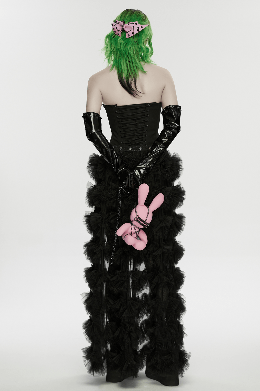 Punk Rabbit Plush Chain Waist Accessory Charm pink bunny plush clipped to black ruffled gothic pants, back view
