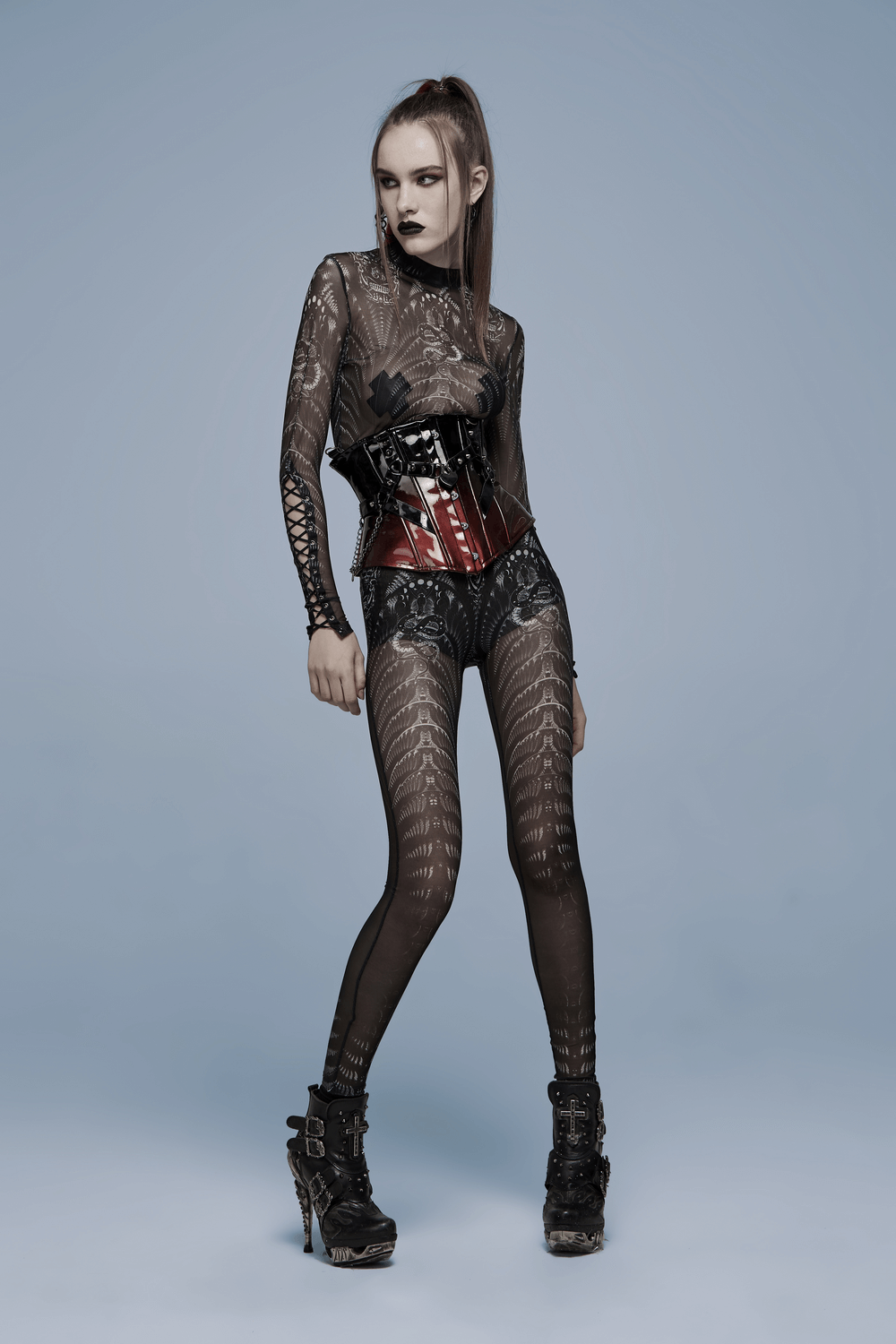 Model in black sheer outfit with corset and edgy leggings, showcasing a gothic style perfect for fashion-forward statements.
