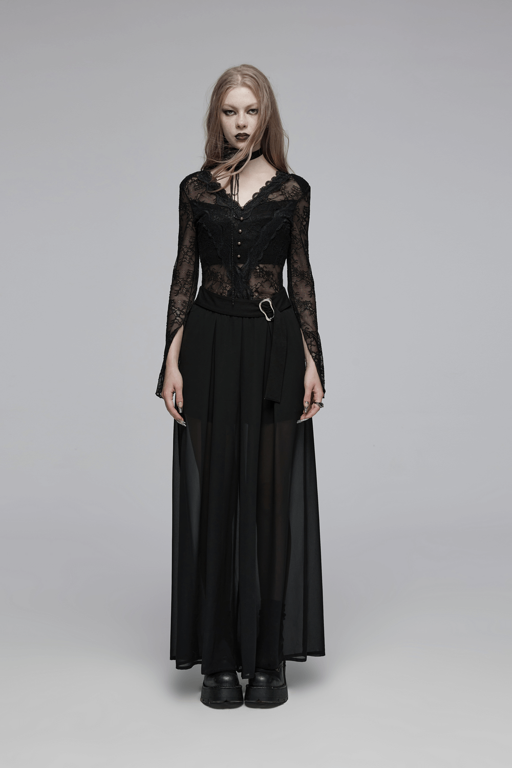 Fashionable model in black sheer chiffon pants with lace top, showcasing edgy punk rave style and adjustable buckle detail.