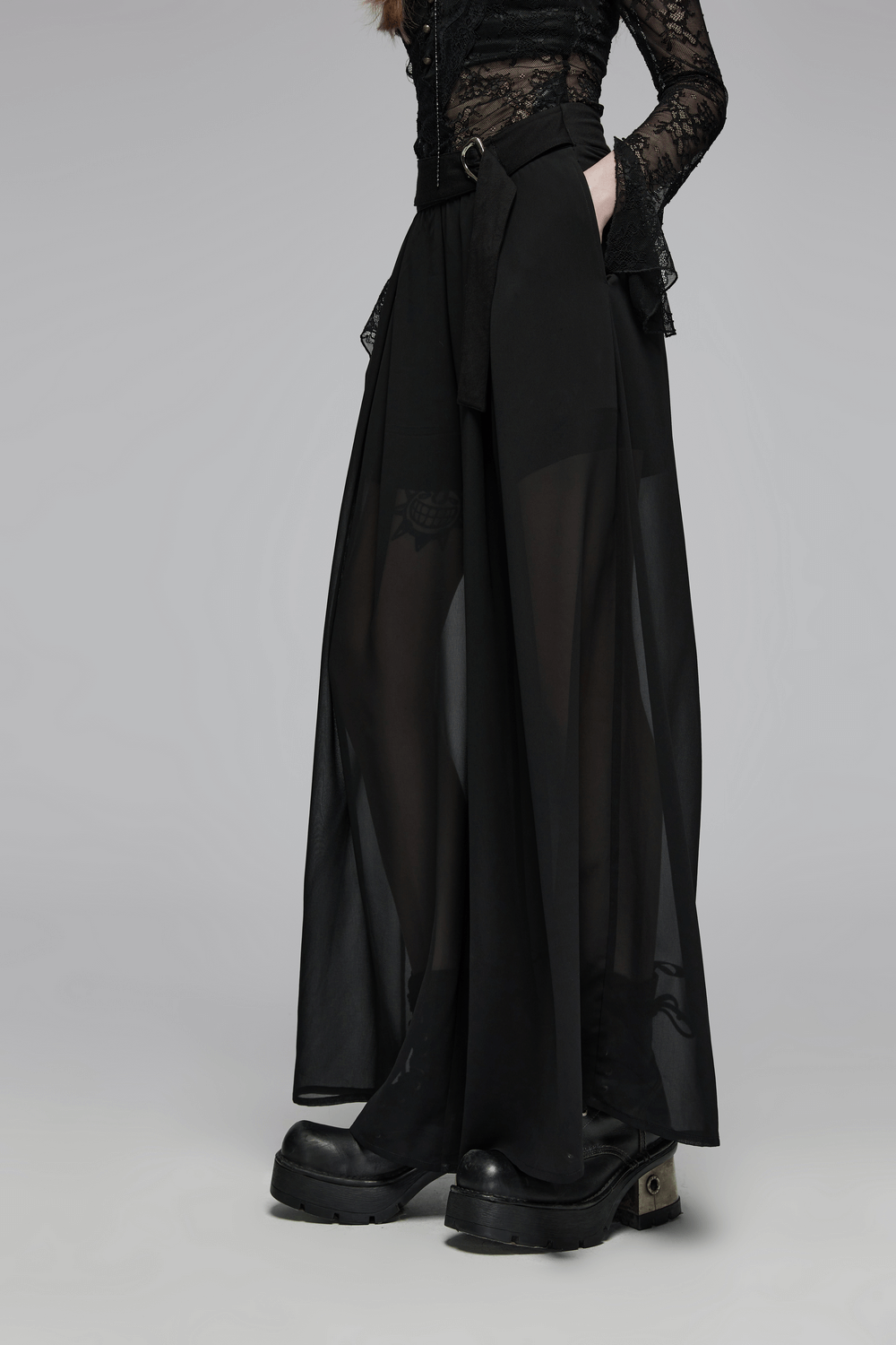 Edgy black chiffon sheer leg pants with buckle detailing, perfect for a punk rave style look.