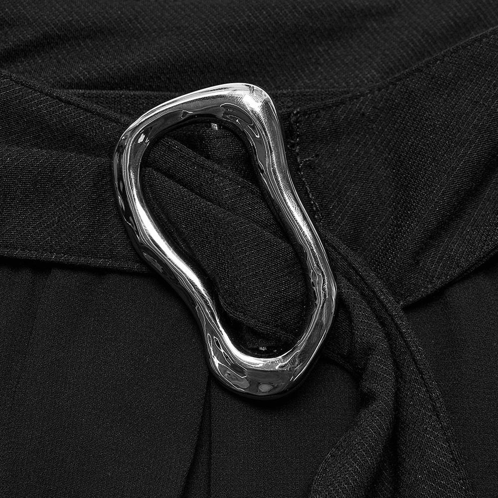 Close-up of a shiny silver buckle detail on black chiffon pants, showcasing edgy Punk Rave style.