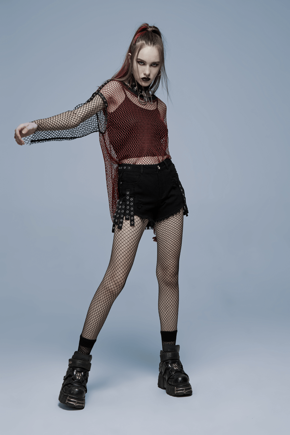 Punk Rave model in black denim shorts with edgy detailing, showcasing Gothic style and rebellious attitude.