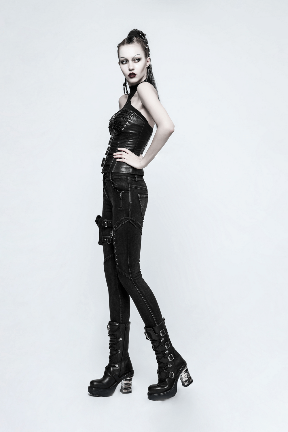 Model showcasing Punk Rave Black Grunge Pocket Eyelets Skinny Jeans with edgy styling and accessories.