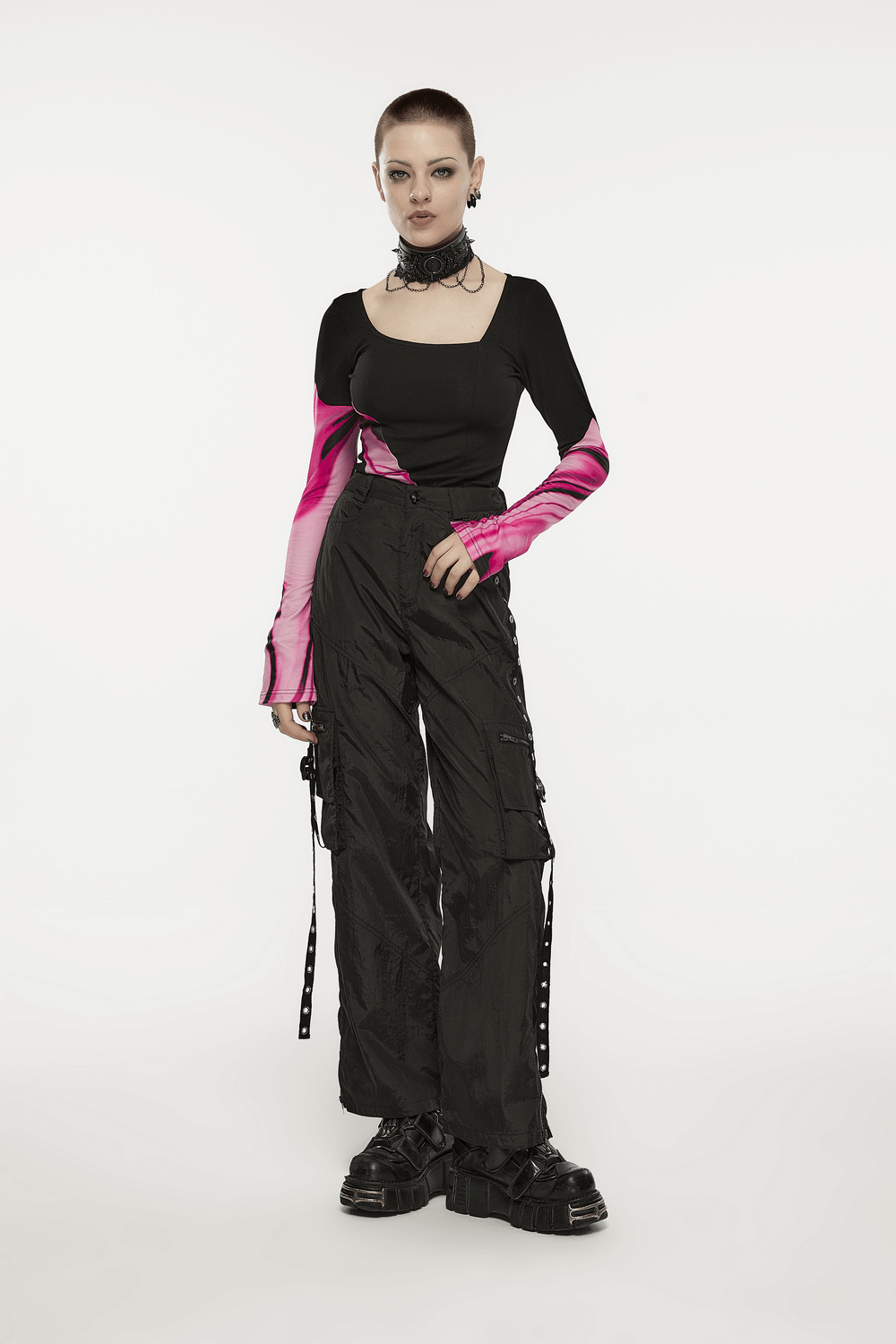 Model wearing punk rave black cargo pants with stylish side chains, showcasing edgy urban tactical fashion.