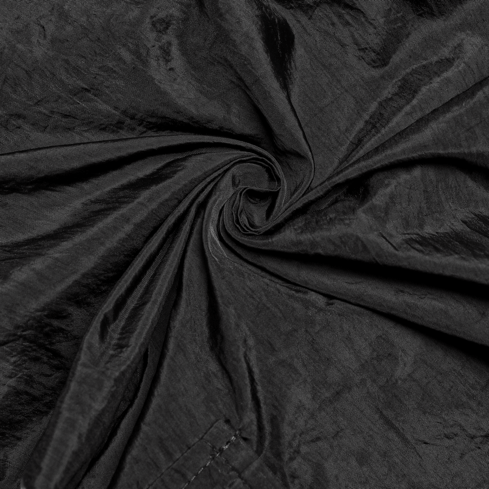 Close-up of crumpled black fabric showcasing texture for punk rave cargo pants.