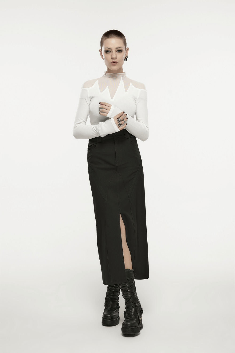Model showcasing a Punk Rave black A-line midi skirt with V-cut front slit, paired with an edgy white top and chunky boots.