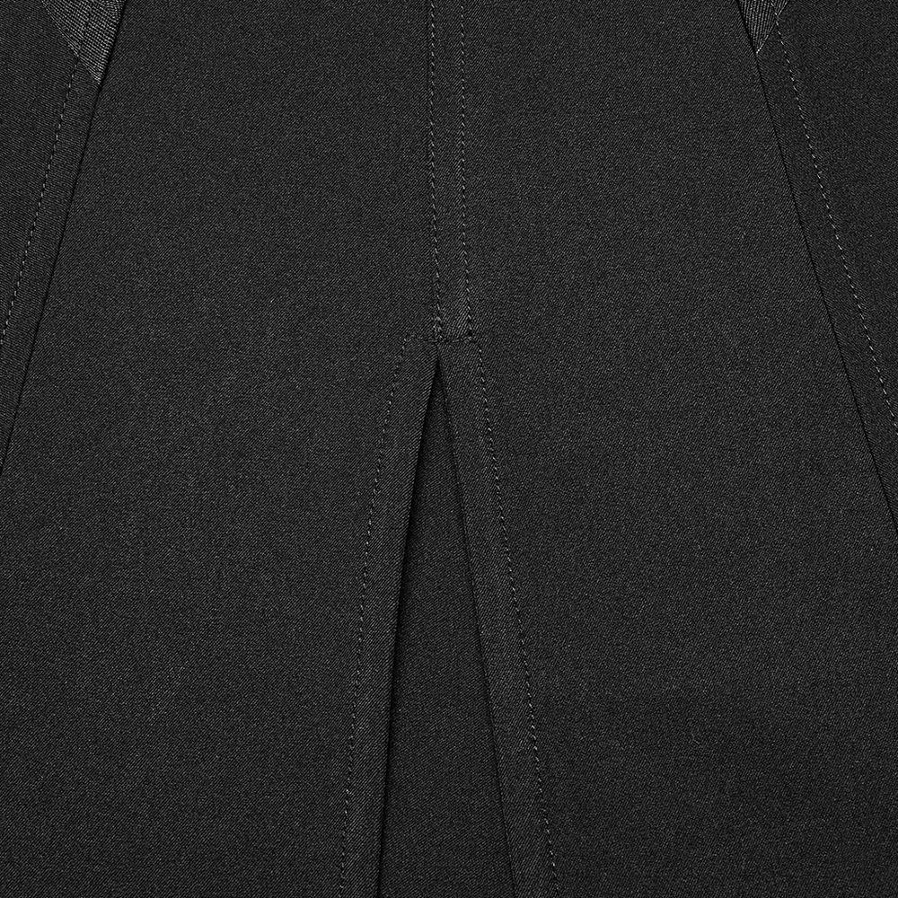 Close-up of punk black A-line midi skirt featuring a dramatic V-cut front slit.