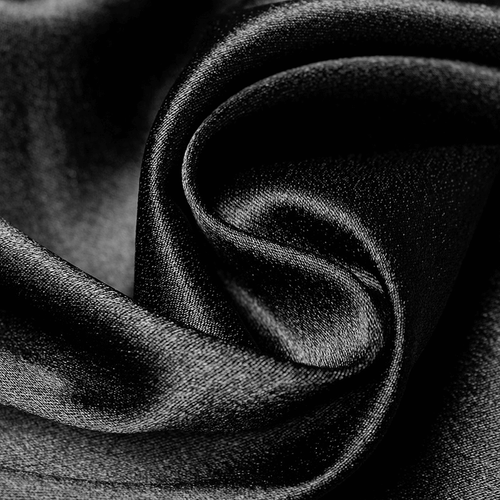Close-up of luxurious black satin fabric, showcasing its soft, smooth texture and elegant sheen.