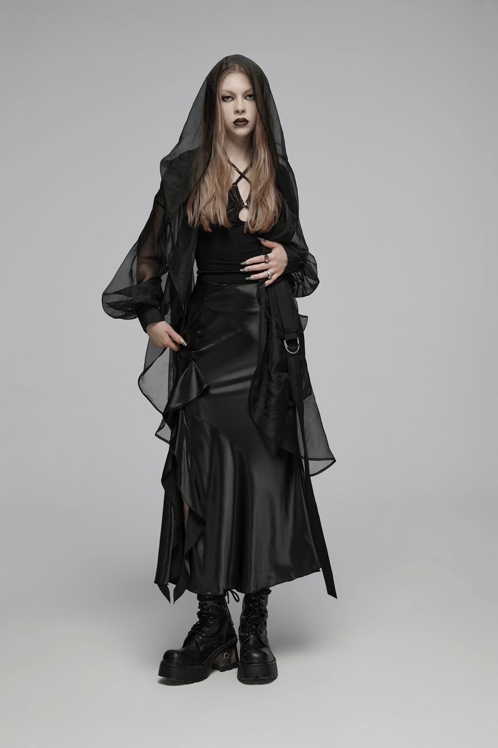 Model wearing a black asymmetric draped skirt with ruffles, exuding dark romance and gothic style.