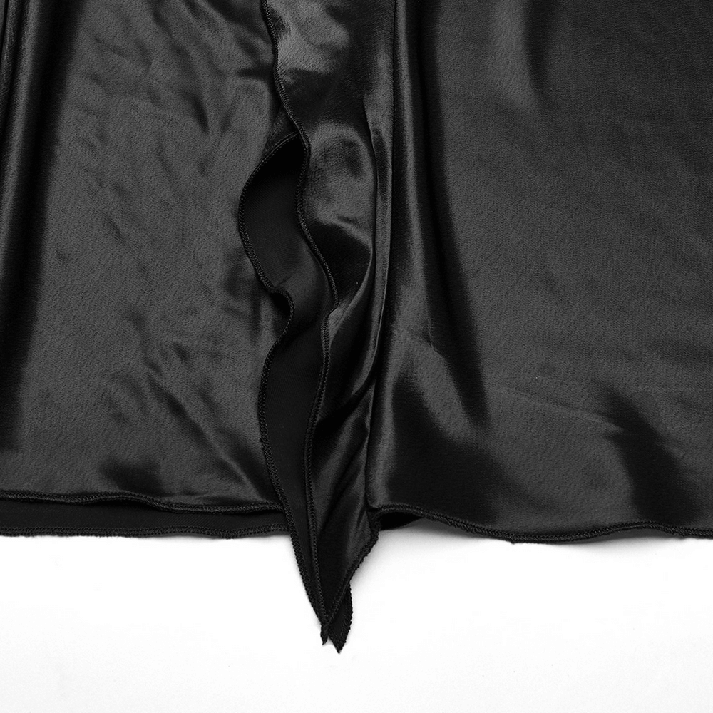 Close-up of soft black fabric with draped asymmetrical cut and ruffles for a gothic A-line skirt.