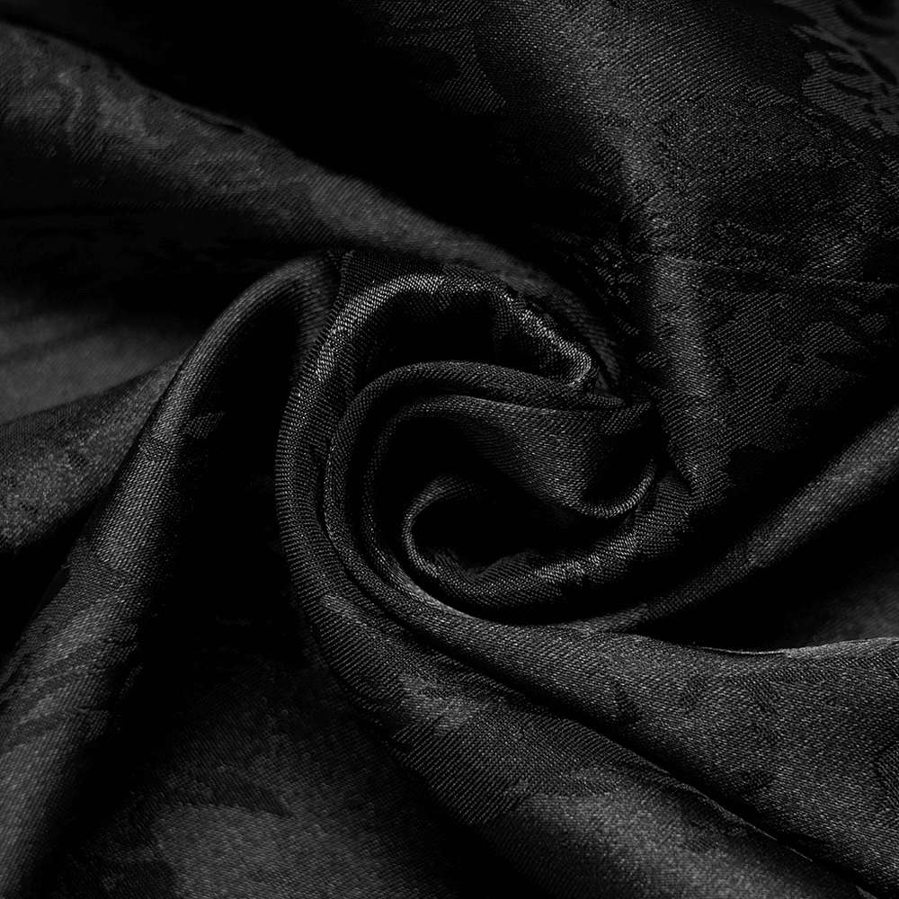 Close-up of soft black jacquard brocade fabric, showcasing intricate texture perfect for gothic fashion.