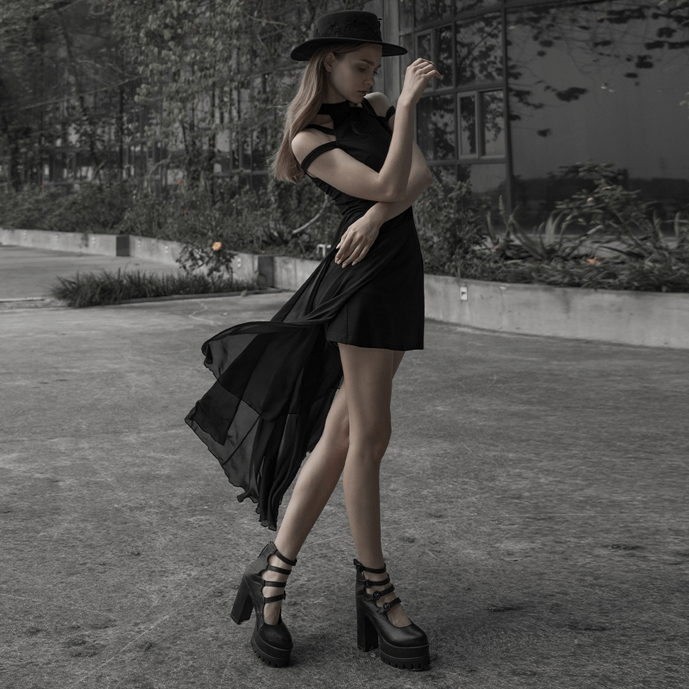 Gothic model in flowing black lace dress and heels, showcasing elegance and dark style in an outdoor setting.