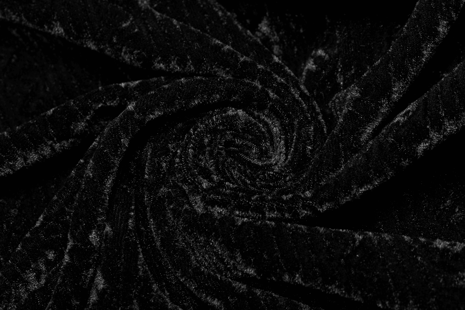 Close-up of luxurious black velvet fabric, showcasing rich texture and elegance perfect for gothic fashion.