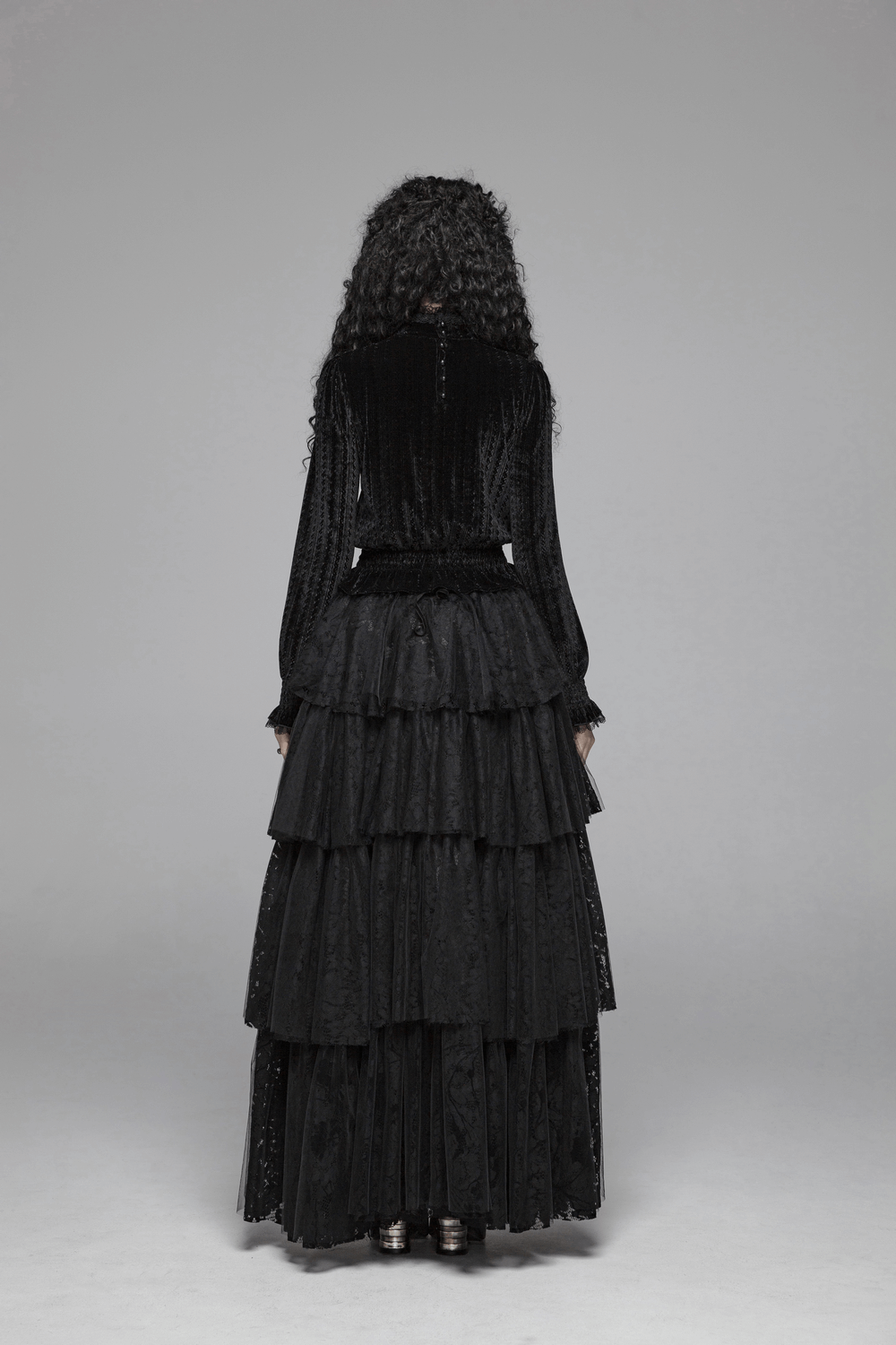 Elegant black velvet gothic blouse with ruffle collar, showcasing back view and tiered skirt detail.