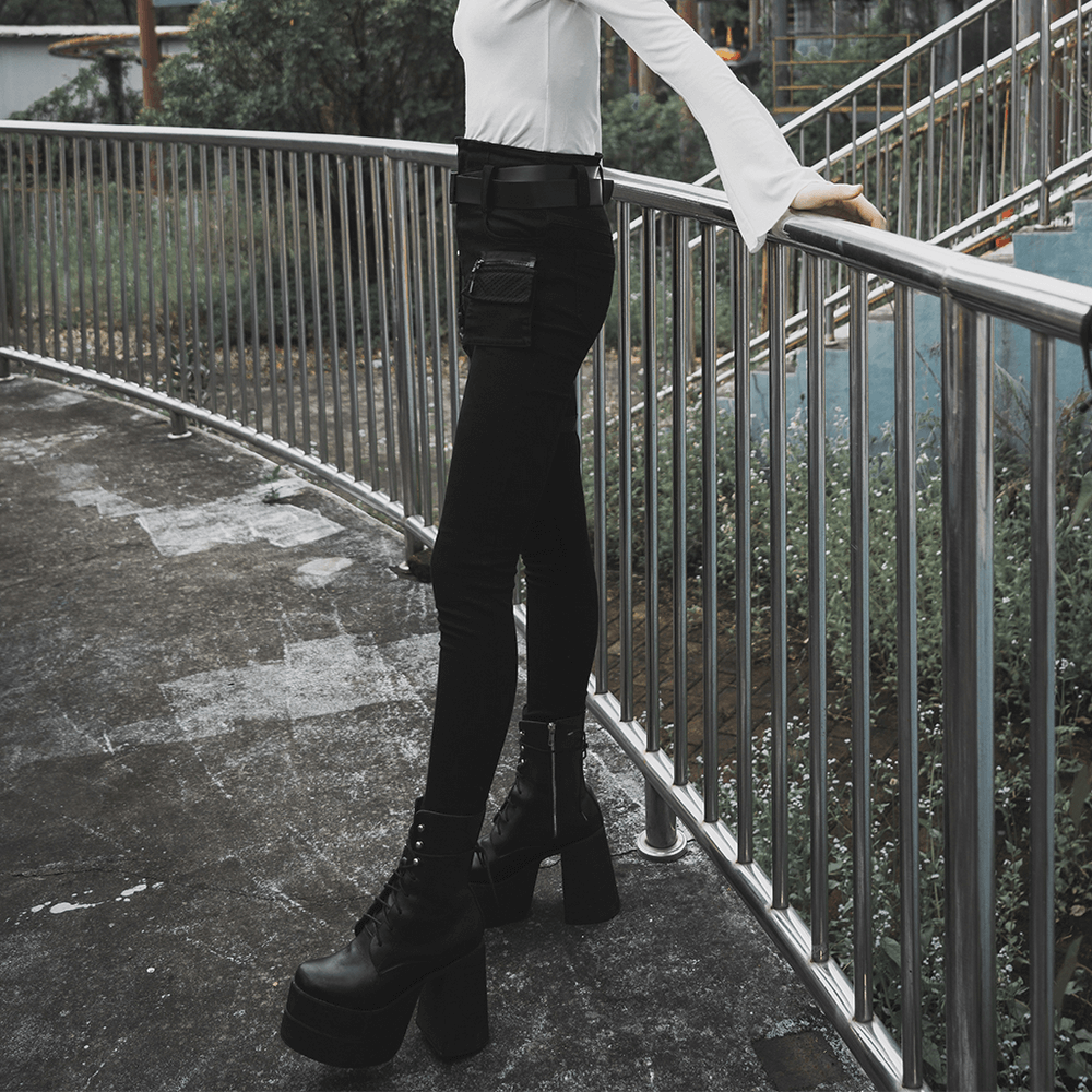 Model showcases Punk Rave Gothic Detachable Belt Mid-Rise Slim Denim Jeans with edgy style and platform boots.
