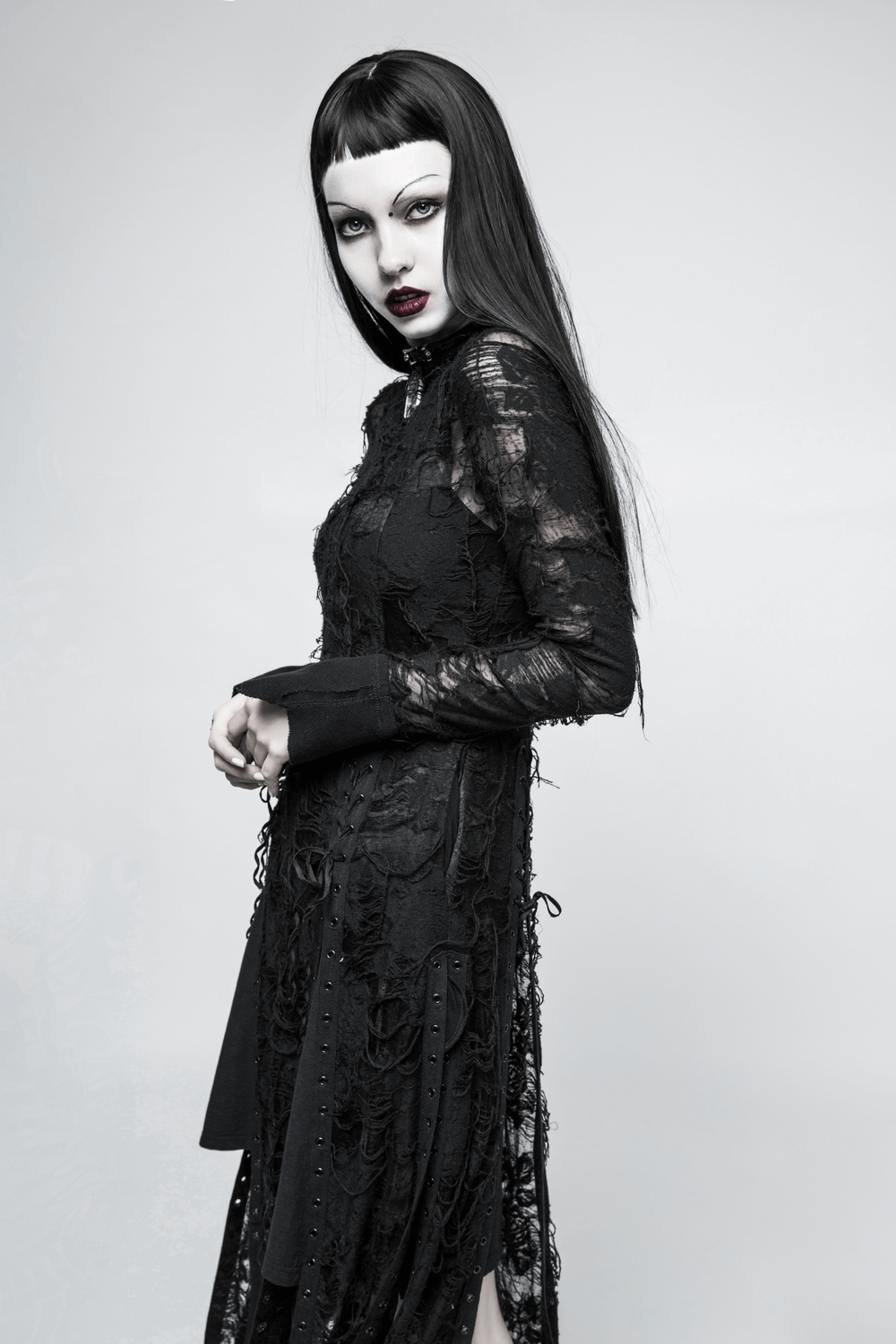 Gothic model in black lace dress with haunting details, showcasing Punk Rave's enchanting style.