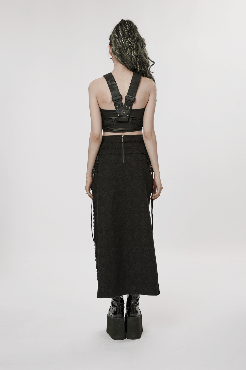 Back view of a model in a Punk Rave high-low asymmetrical jacquard skirt paired with a stylish harness top.