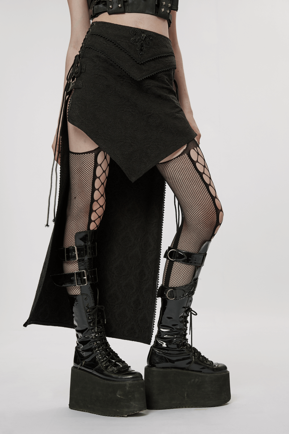 Punk Rave high-low asymmetrical jacquard skirt paired with fishnet tights and platform boots for an edgy Gothic look.