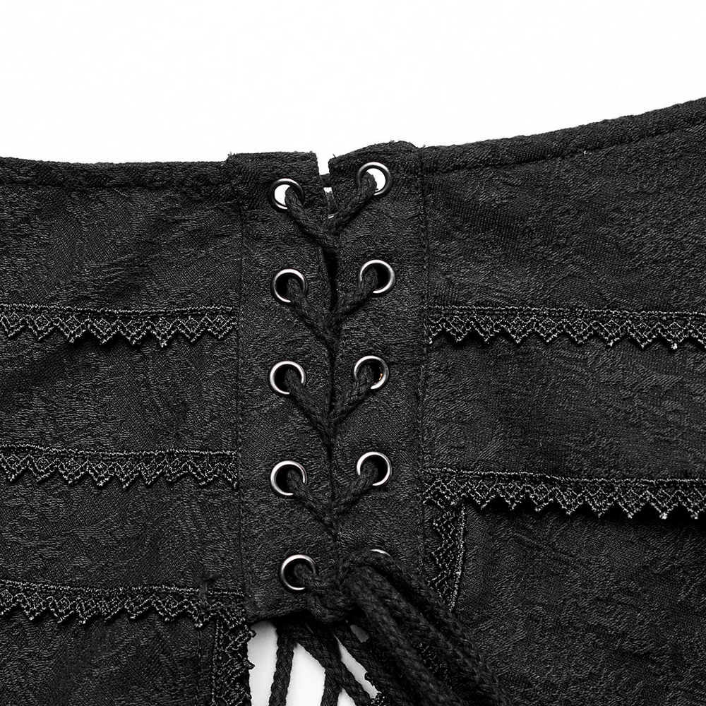 Detail of punk rave skirt's lace-up back with black jacquard fabric and delicate lace trim.