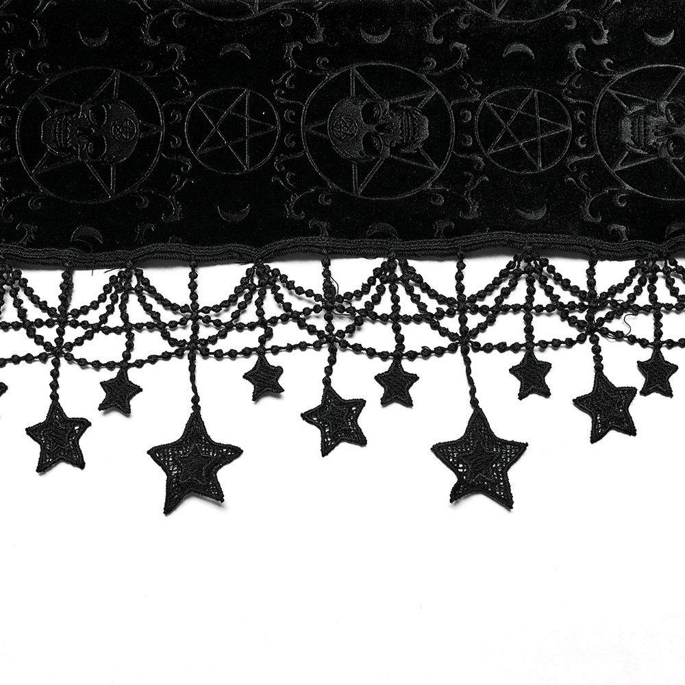 Close-up of black velvet cape hem featuring pentagrams and hanging star tassels, perfect for gothic outfits.