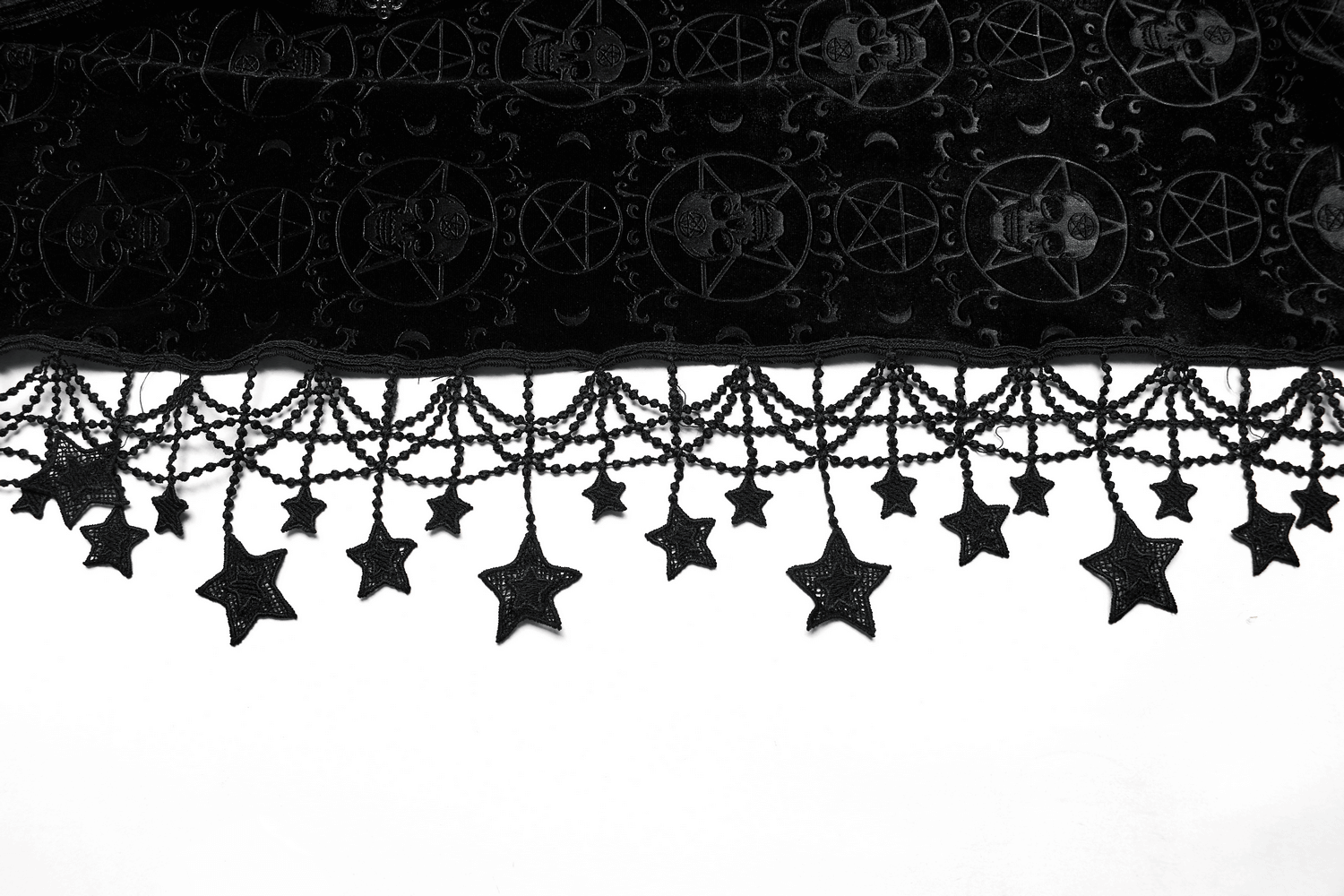 Close-up of gothic velvet cape with pentagram pattern and star tassel trim, enhancing any dark fashion ensemble.