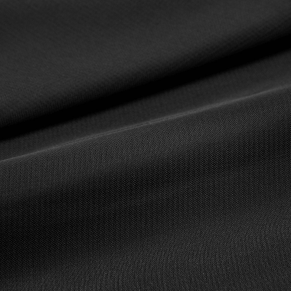Close-up of black textured twill fabric, showcasing the edgy material for the Punk Rave skirt.