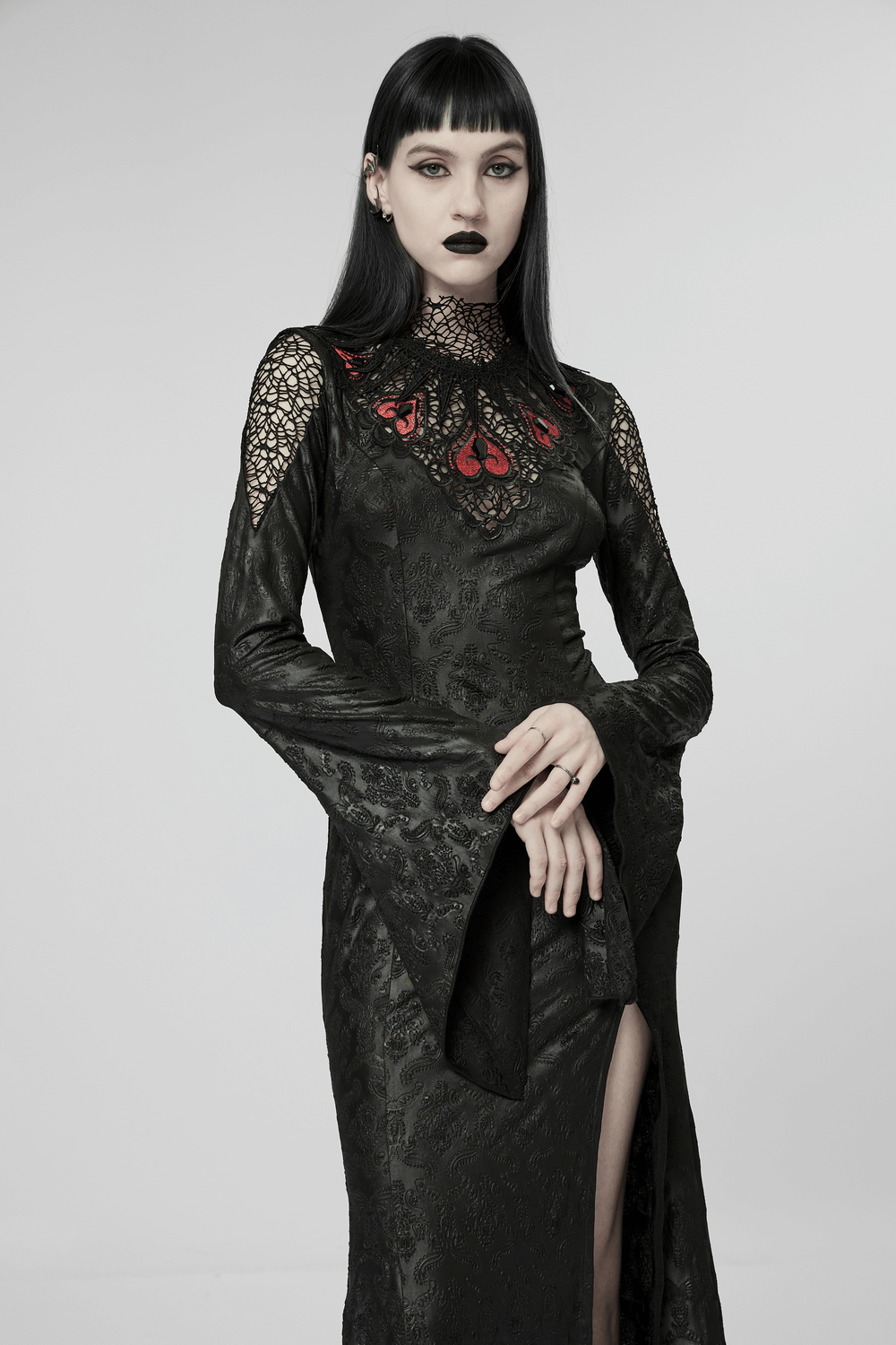 Gothic black mesh gown with embroidered roses; flared sleeves and a plunging neckline, perfect for dark elegance.