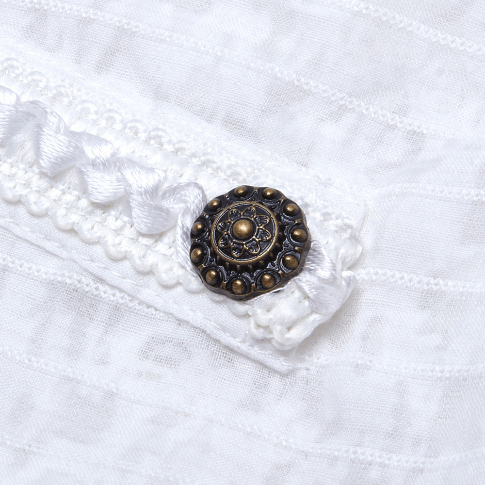 Close-up of vintage metal accent on white lace dress, featuring braided detail and decorative button for elegant steampunk style.