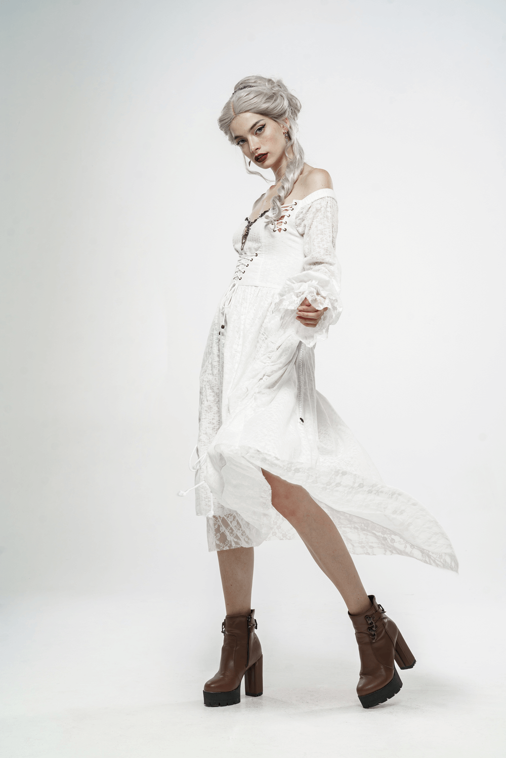 Punk Rave white Gothic lace dress with lantern sleeves and metal accents, showing a model in stylish boots.