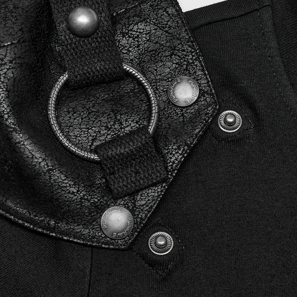 Close-up of cracked leather detailing and metal hardware on edgy punk t-shirt with detachable panel.