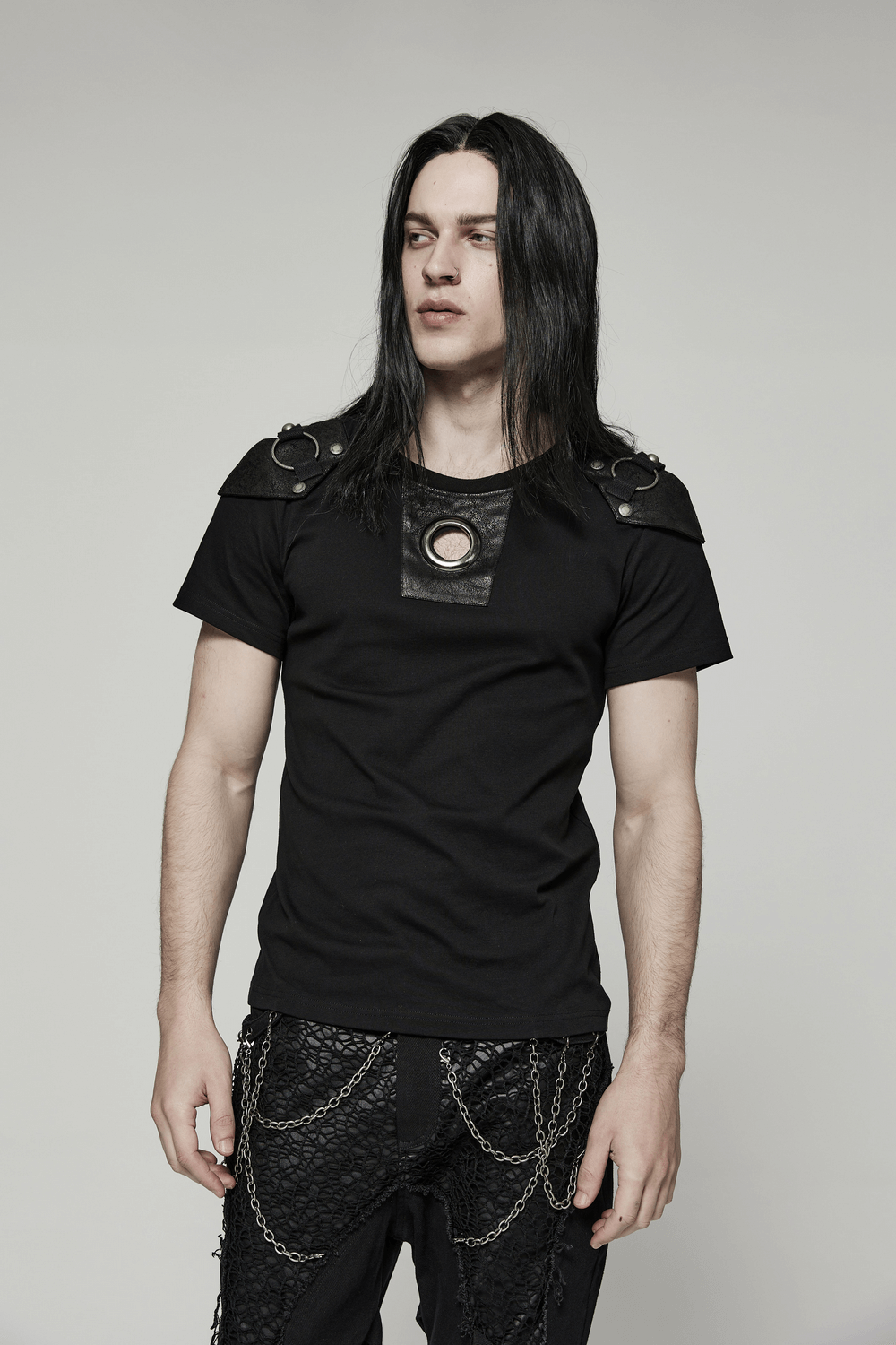 Stylish male model wearing a punk rivet armor t-shirt with detachable panel and cracked leather details.