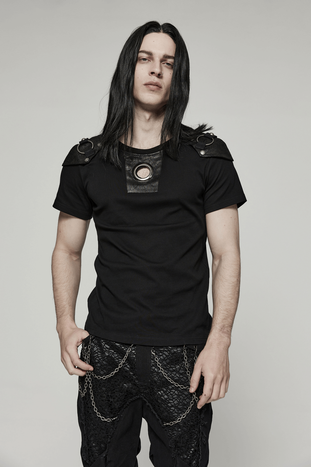 Edgy punk t-shirt with detachable armor panel and cracked leather detailing, worn by male model.