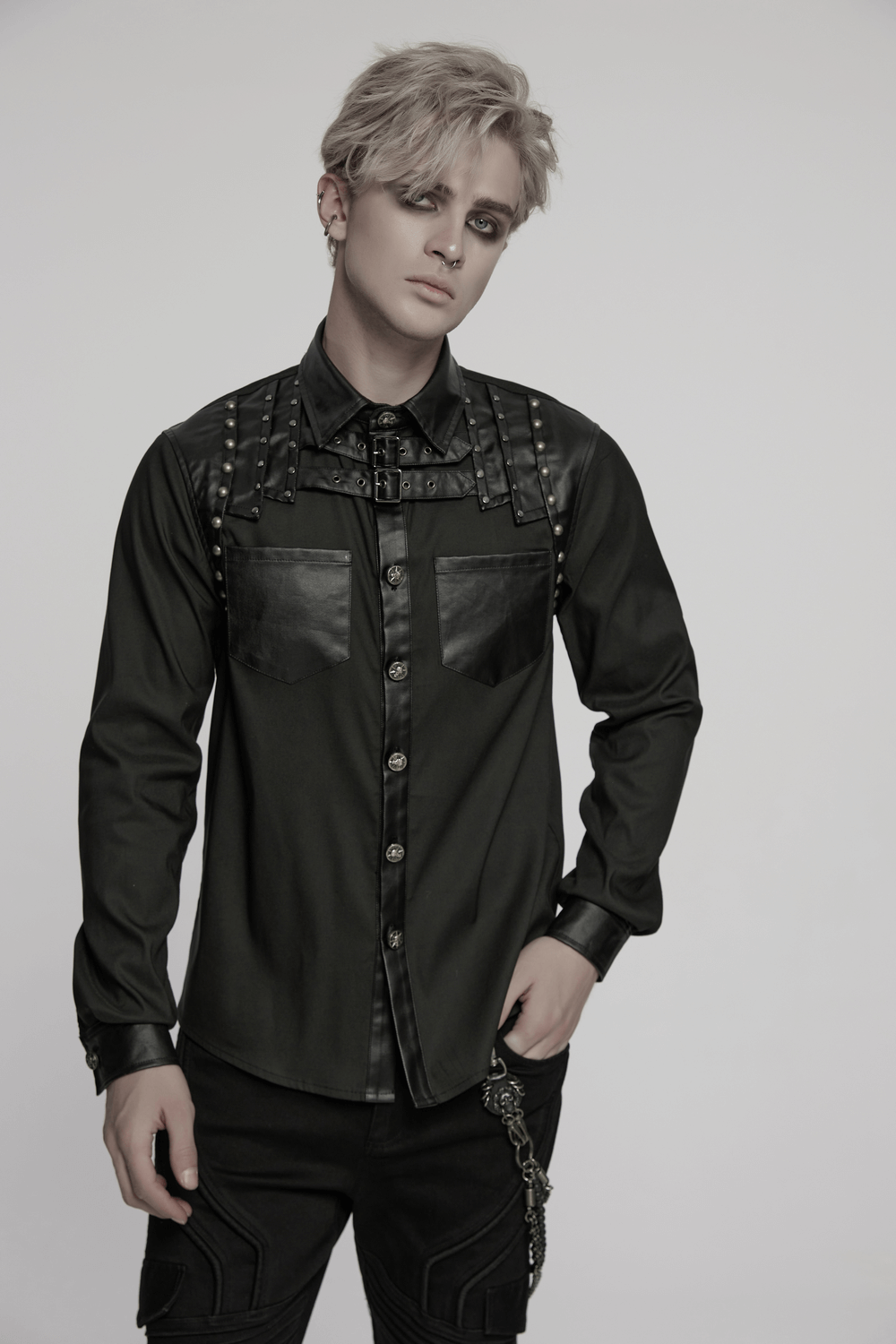 Punk riveted leather patchwork men's shirt showcasing edgy street style with buttons and unique shoulder detail.